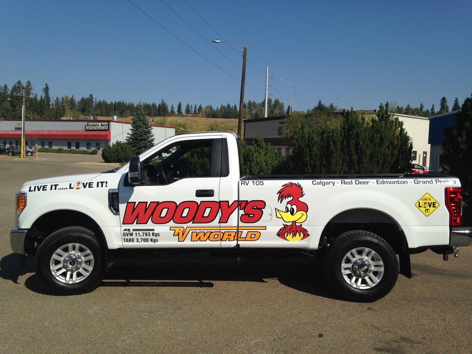 white truck with red and orange company logo on it