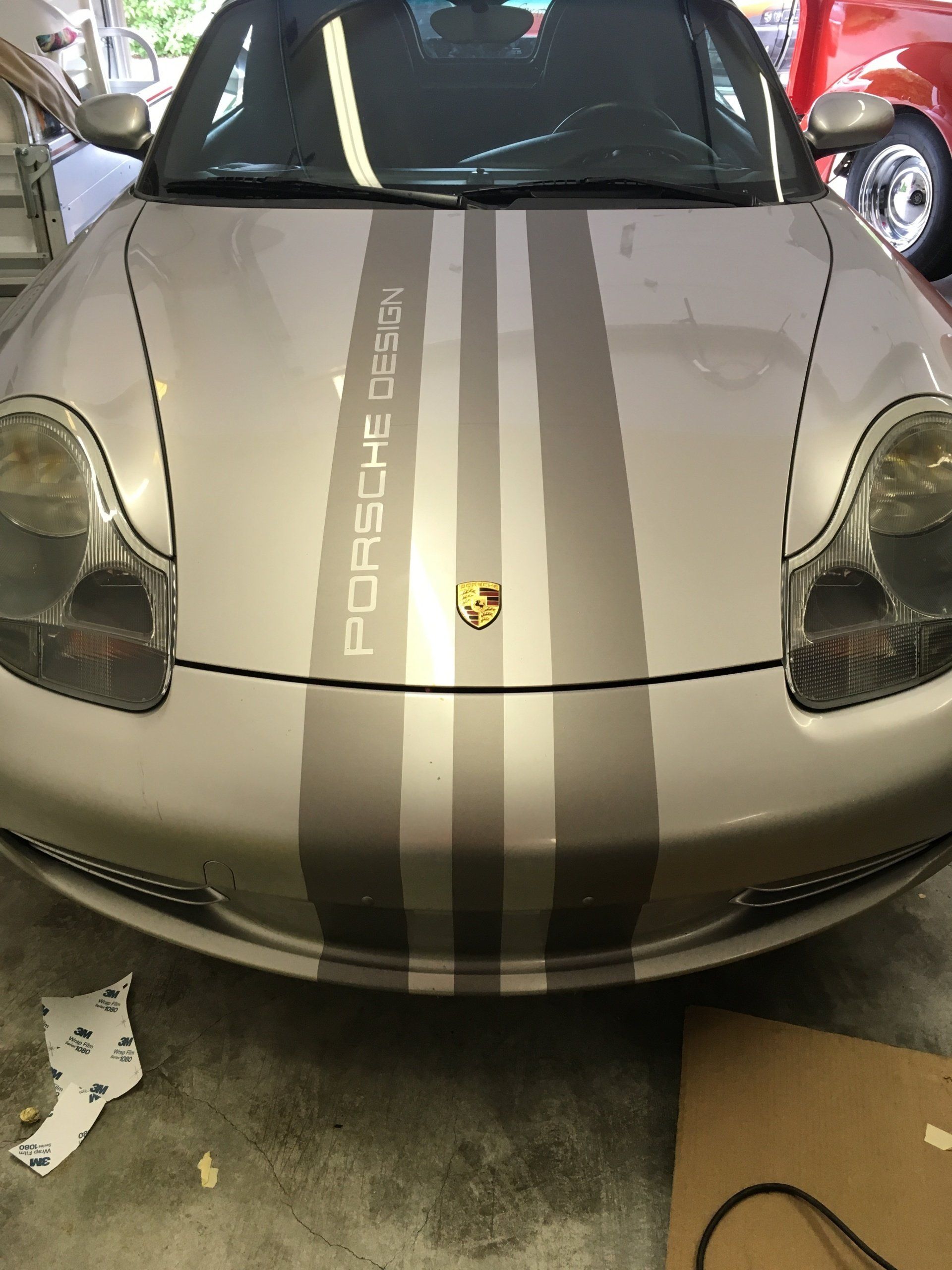 silver car with black racing stripes