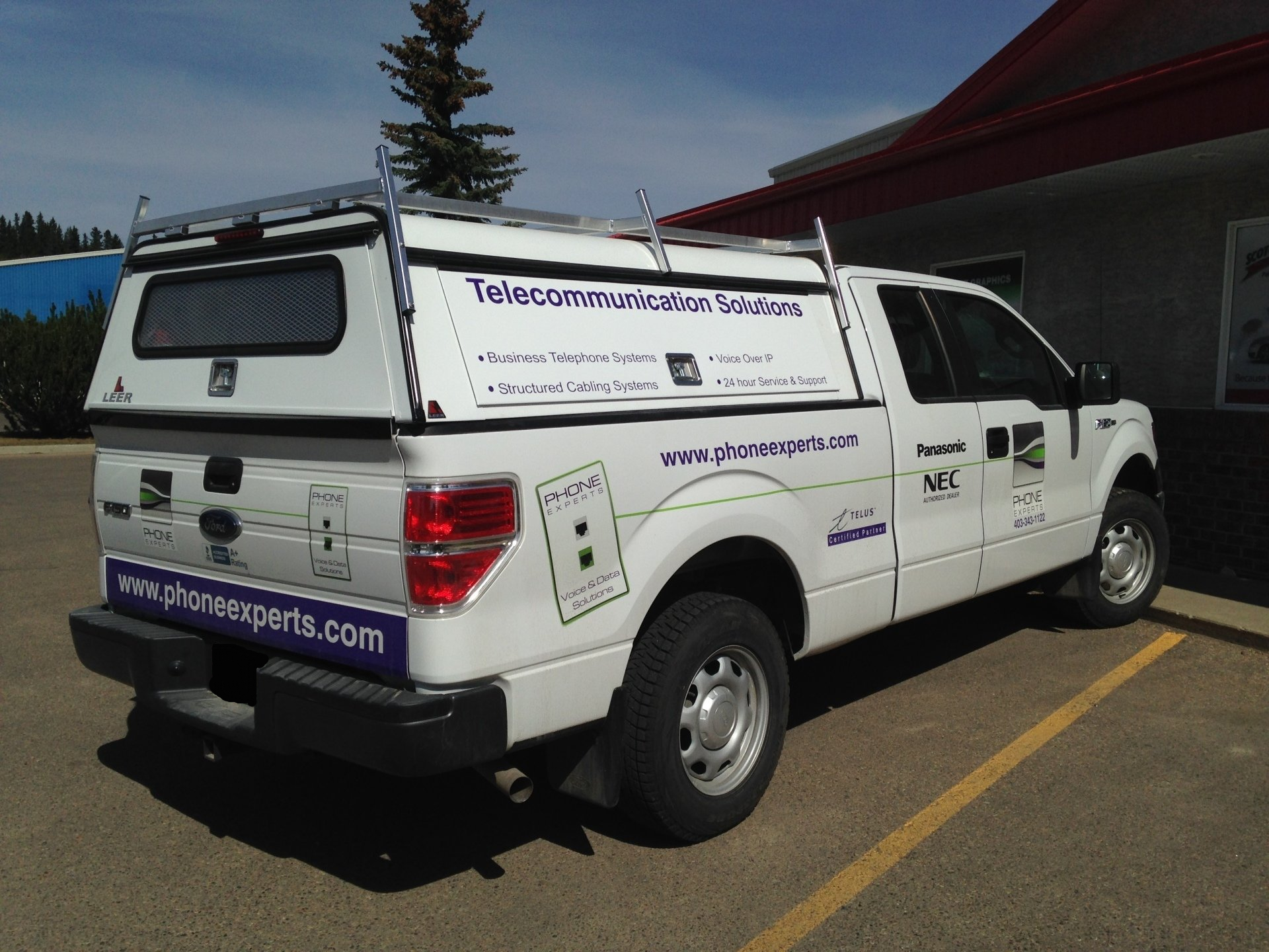 side view of white truck with paint job on the side