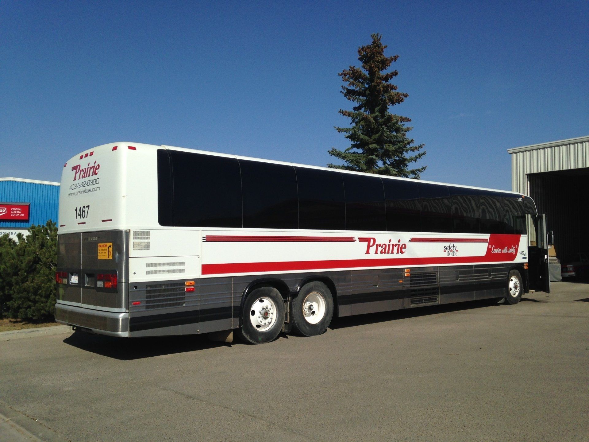 large rv with red decals alongside it