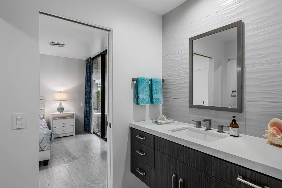 A bathroom with a double sink and a mirror.