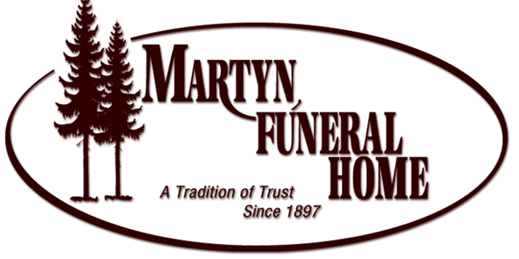 A logo for martin funeral home with two trees on it