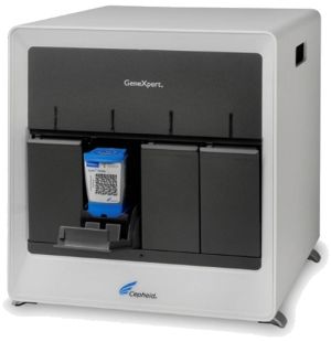 Gray desktop DNA analyzer machine with a blue sample cartridge inserted in the front slot