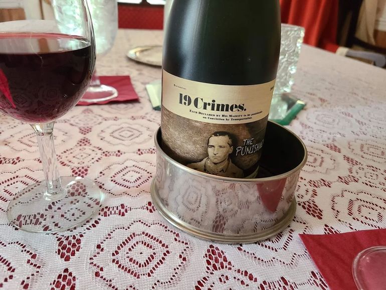 Sliced steak with herbs on a plate, side of potatoes, candlelit restaurant setting