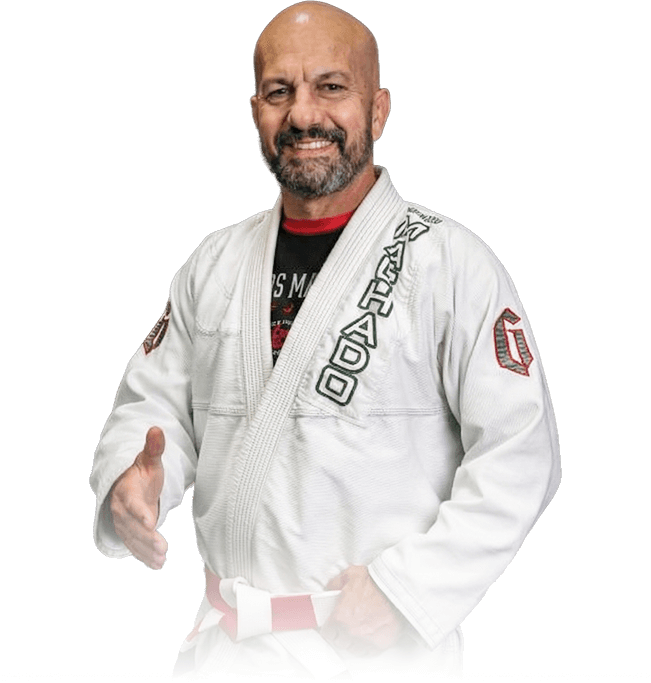 Man pointing, smiling, wearing black hoodie; arm tattoo visible.