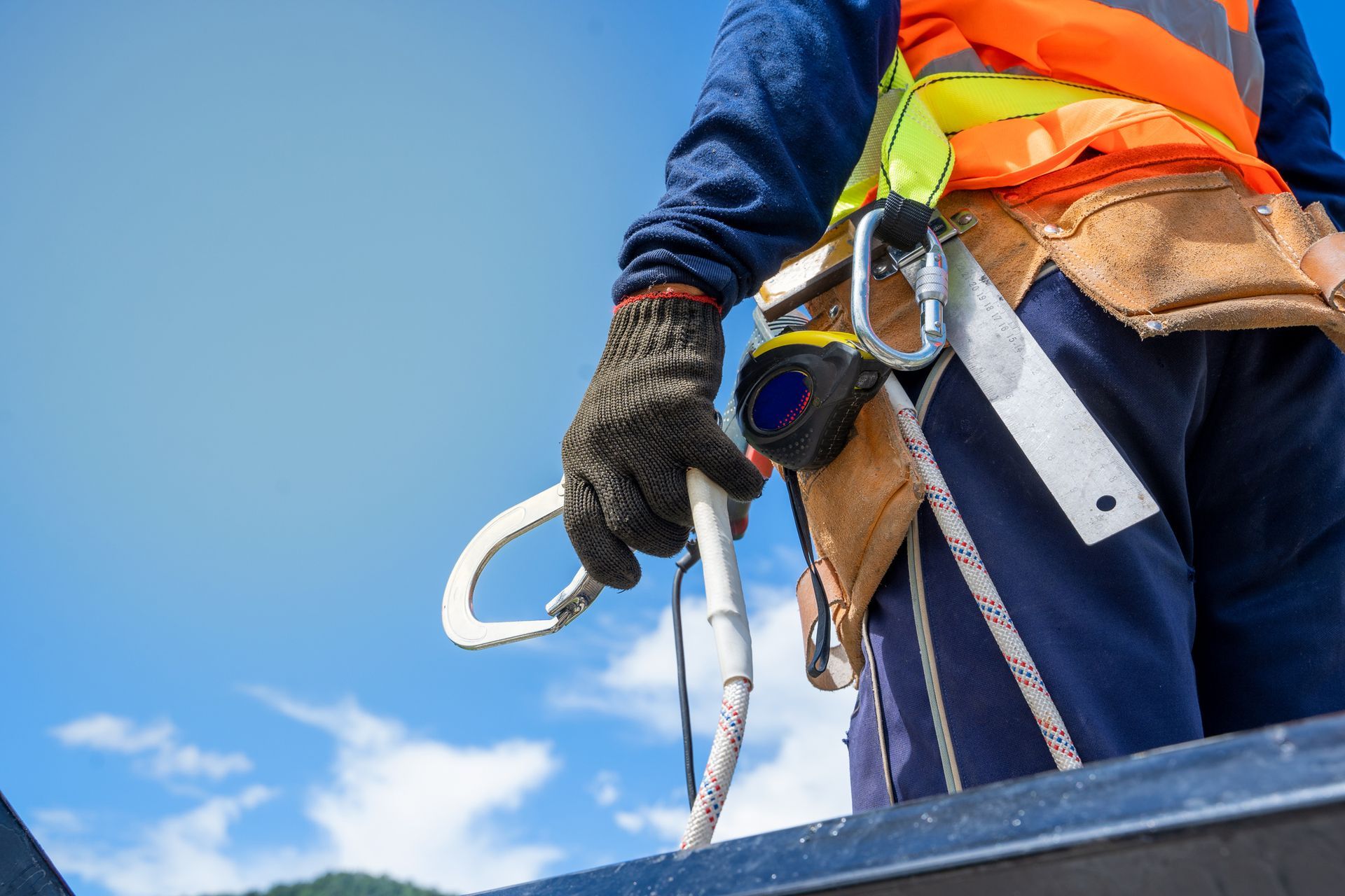 Construction worker wearing safety harness and safety line
