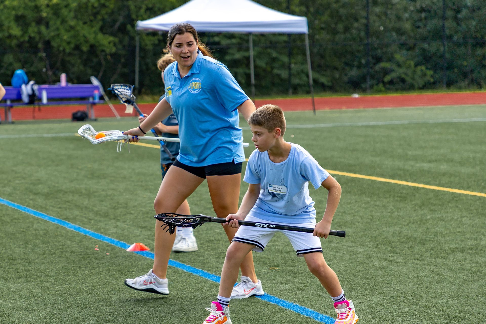 A young boy is holding a basketball on a basketball court.
