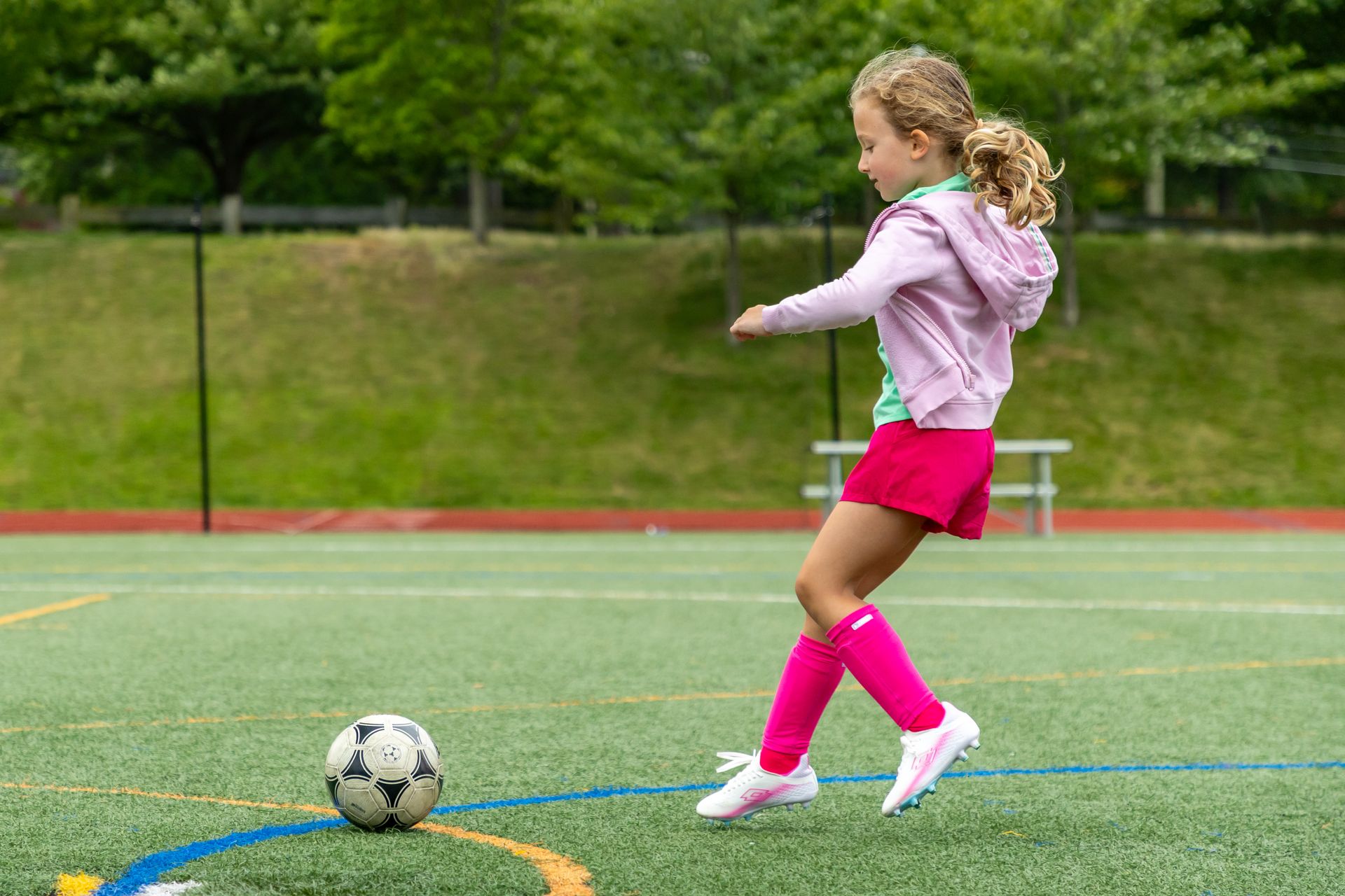 A group of children are playing soccer on a field