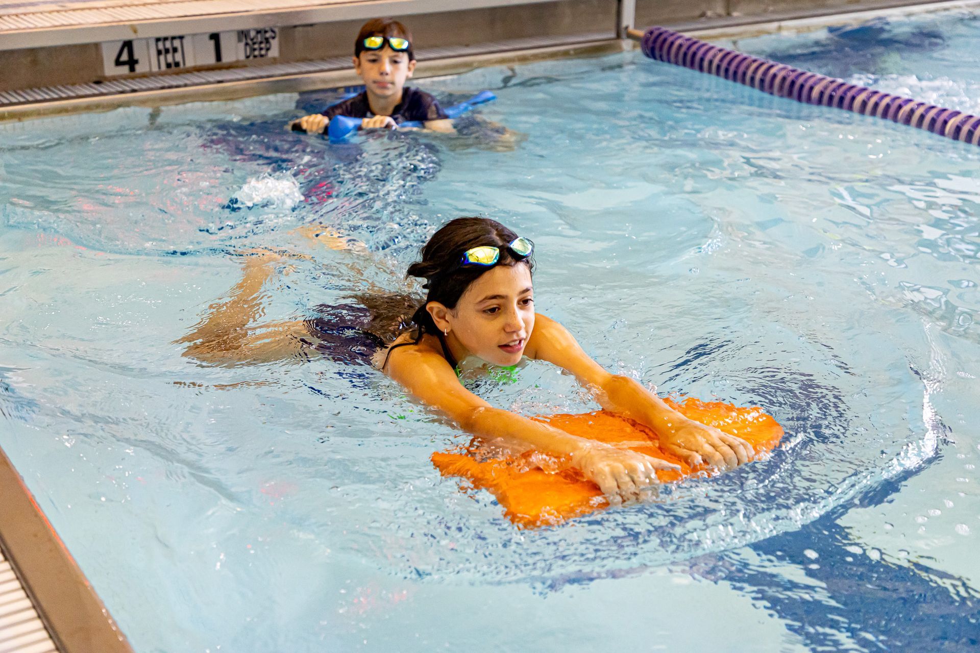 Two young boys are holding hands on a field.