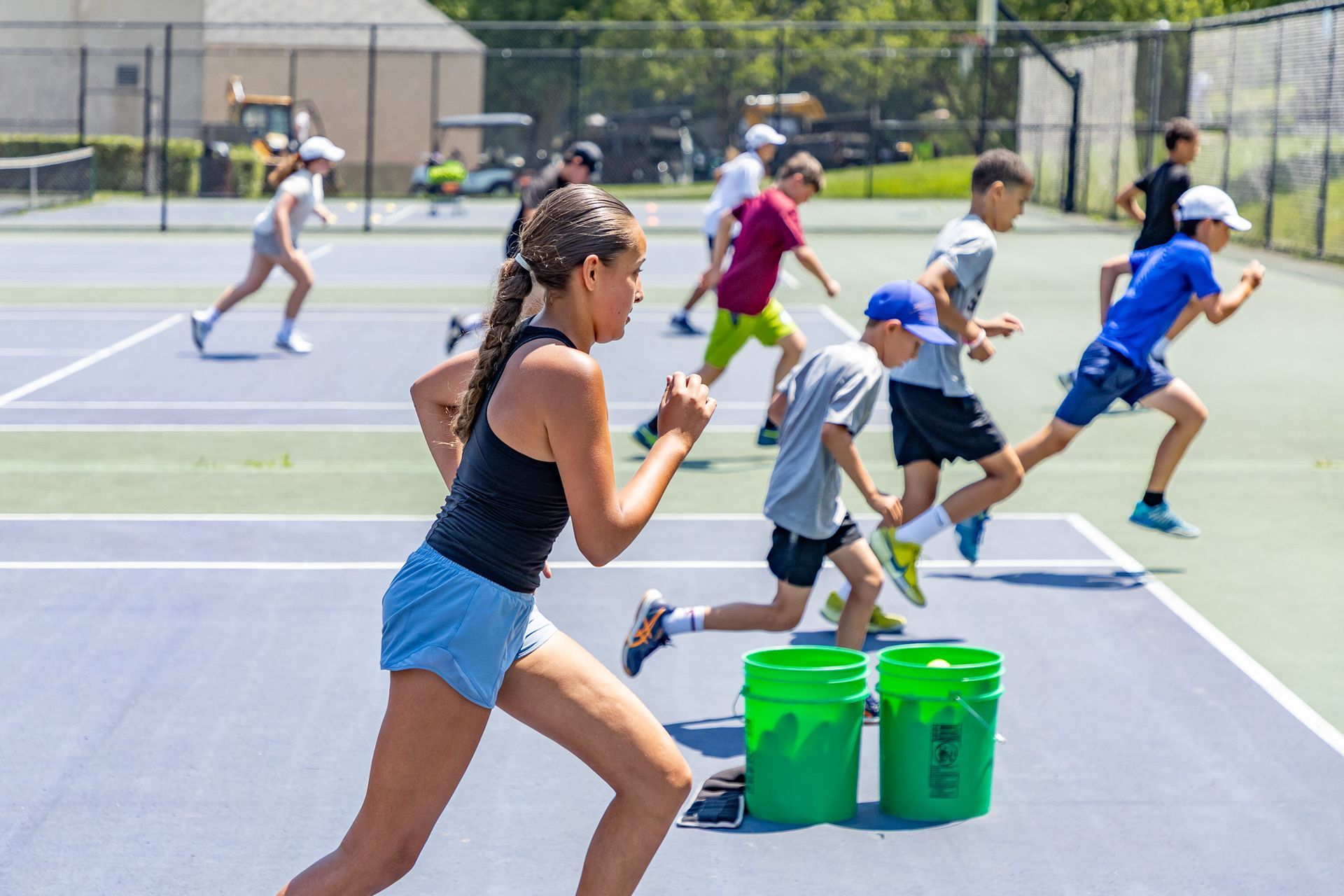 A group of young girls are playing soccer on a field