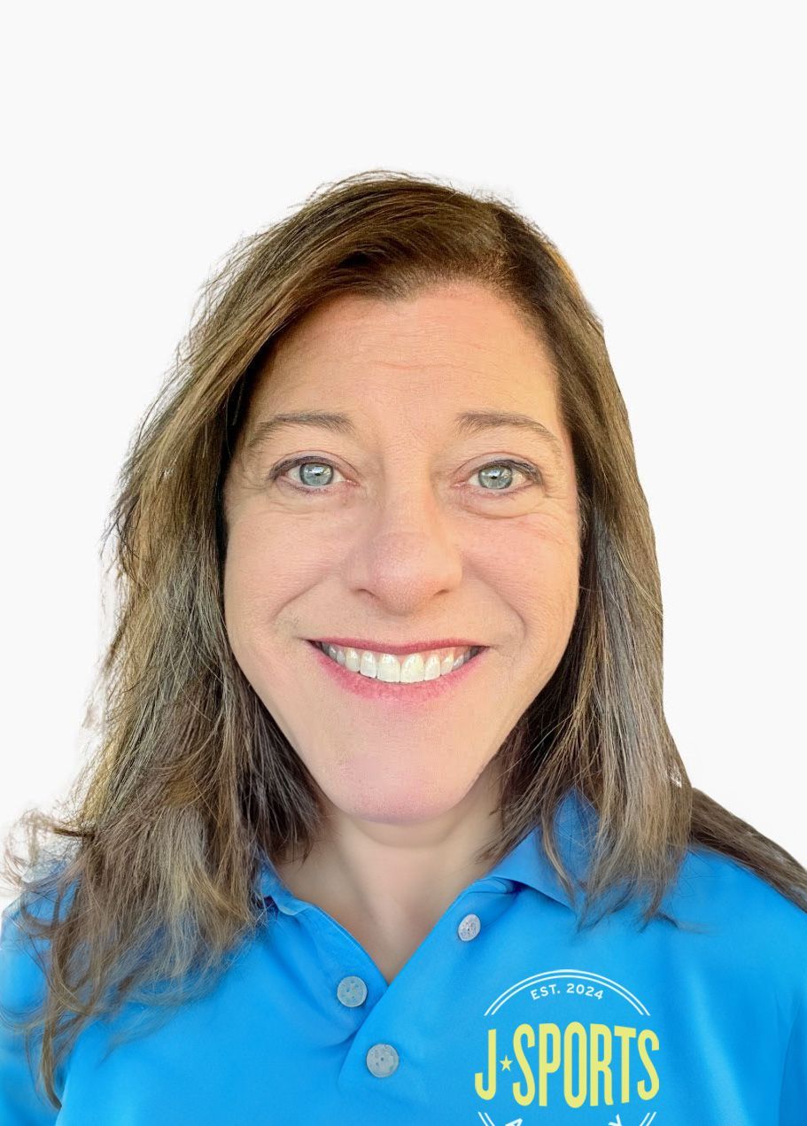 A woman wearing glasses and a blue shirt is smiling for the camera.
