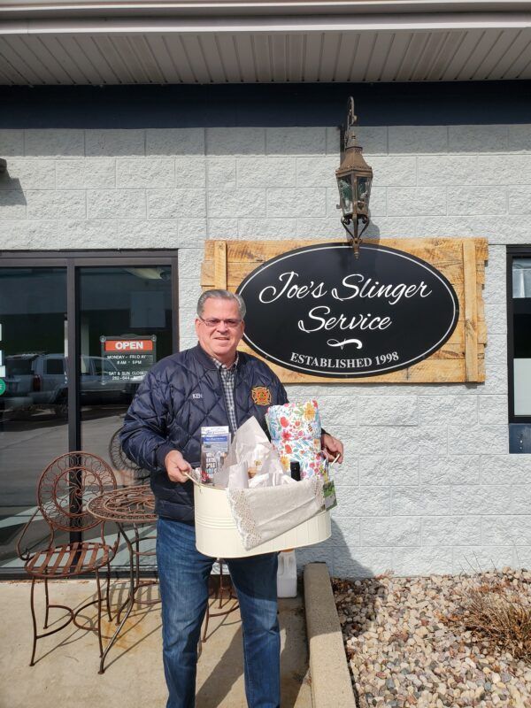 Man holding gift basket in front of 
