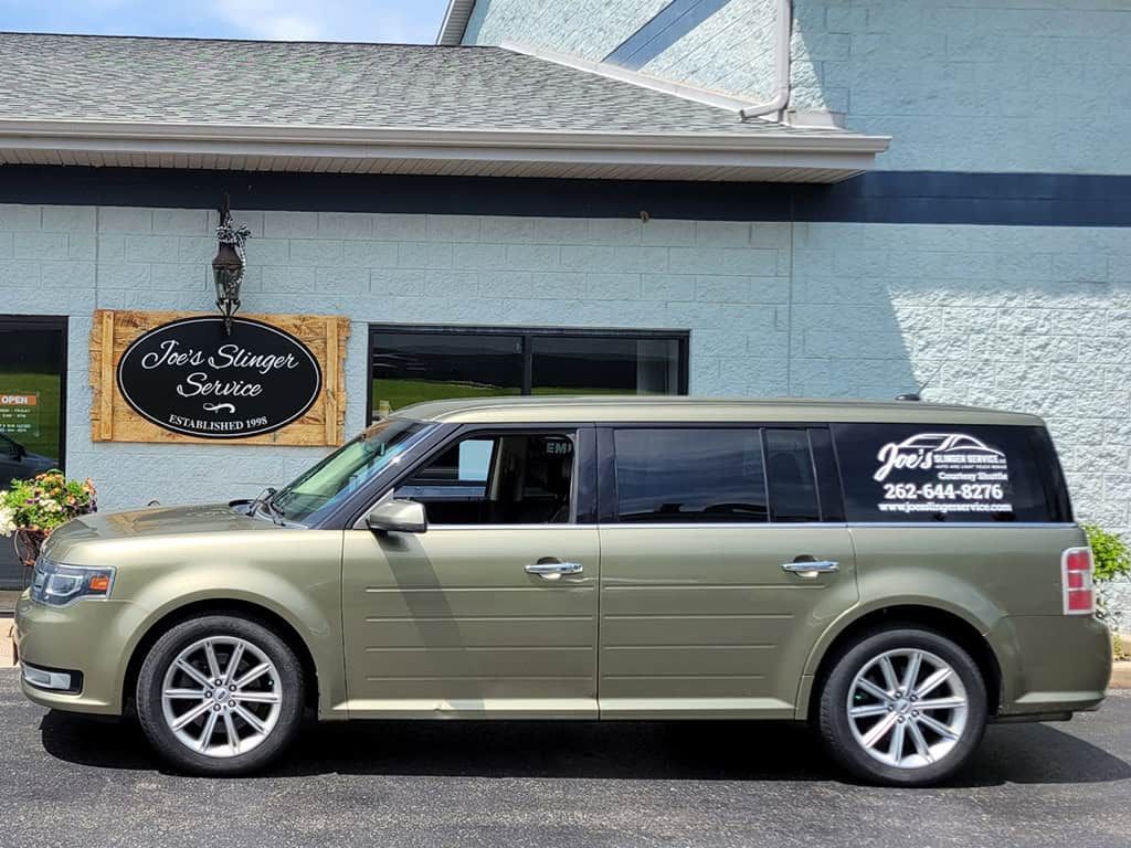 Tan Ford Flex vehicle parked in front of Joe's Limo Service building. | Joe's Slinger Service