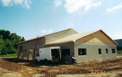 Building under construction with a white delivery truck parked outside. | Joe's Slinger Service