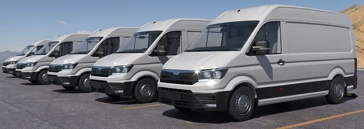 Several white vans parked in a row, under a clear blue sky.