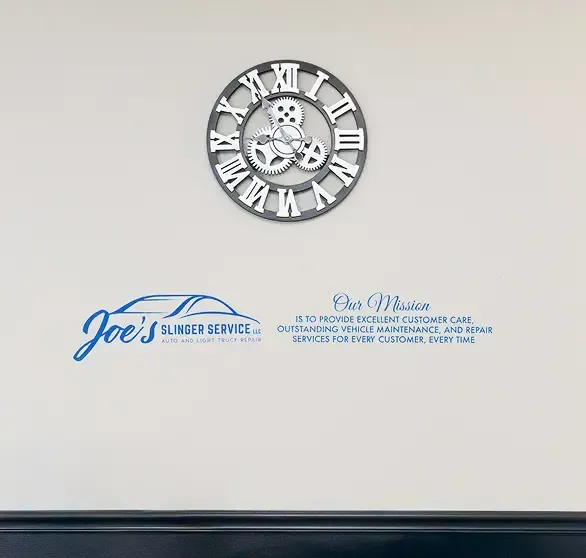 Wall with a clock and Joe's Blinder Service logo; mission statement in text.