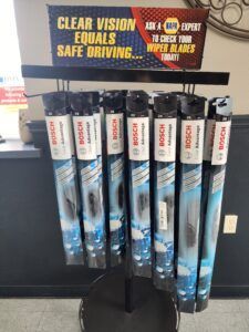 Display of Bosch wiper blades with sign about clear vision at a NAPA Auto Parts store. | Joe's Slinger Service