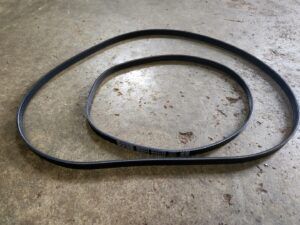 Black serpentine belt on a concrete surface. | Joe's Slinger Service