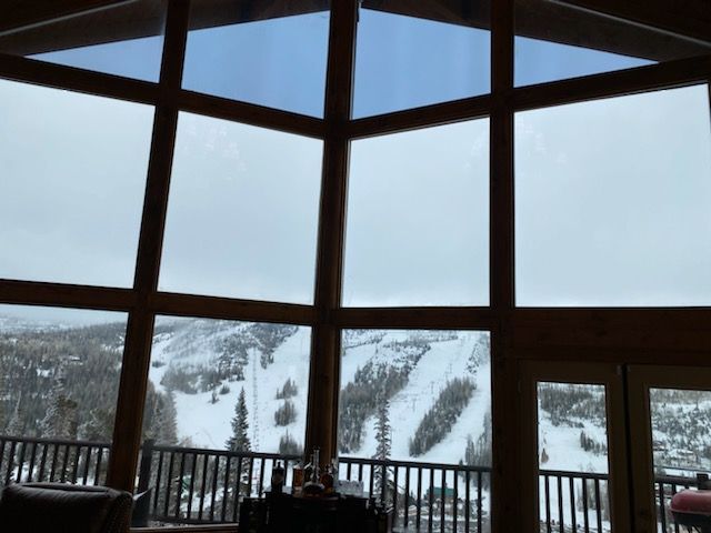 A large window with a view of a snowy mountain