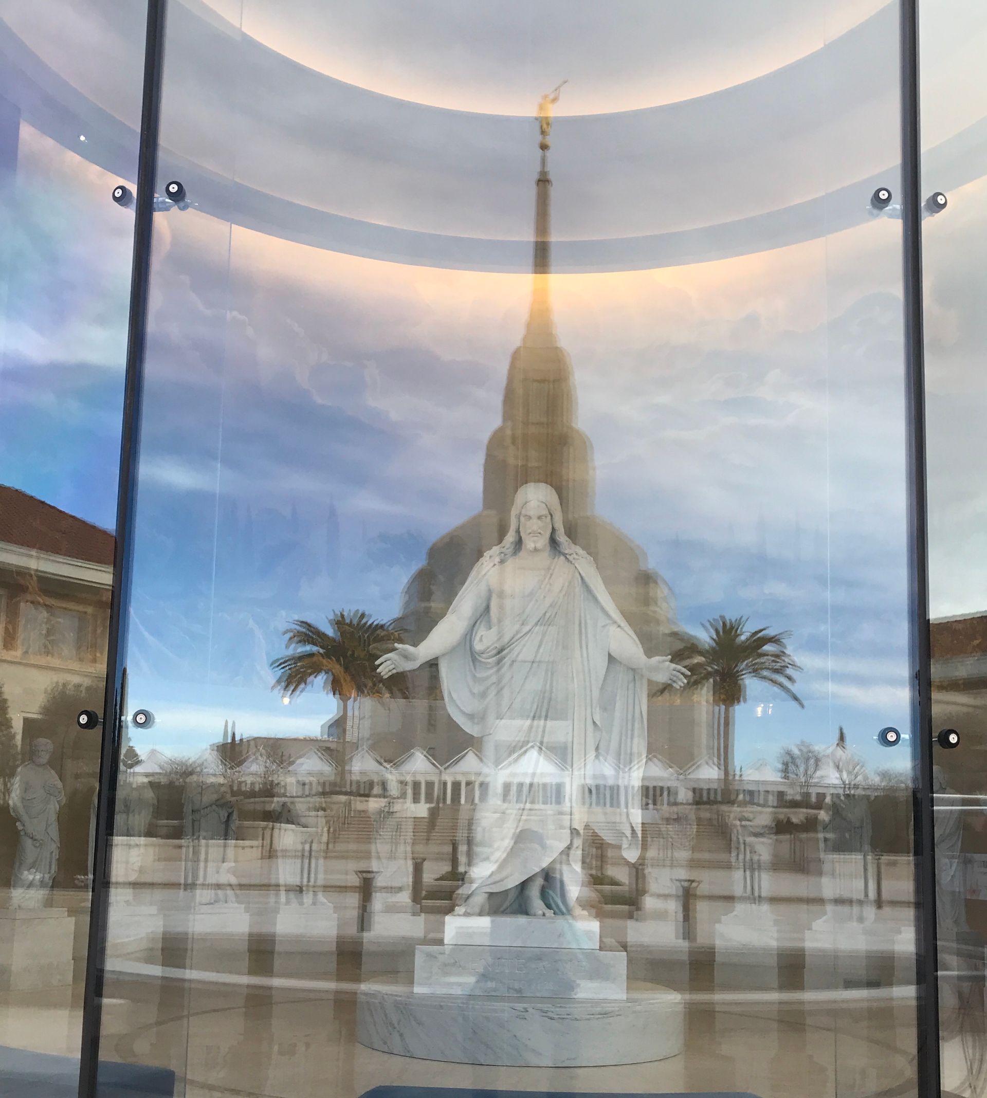 A statue of jesus in a glass display case