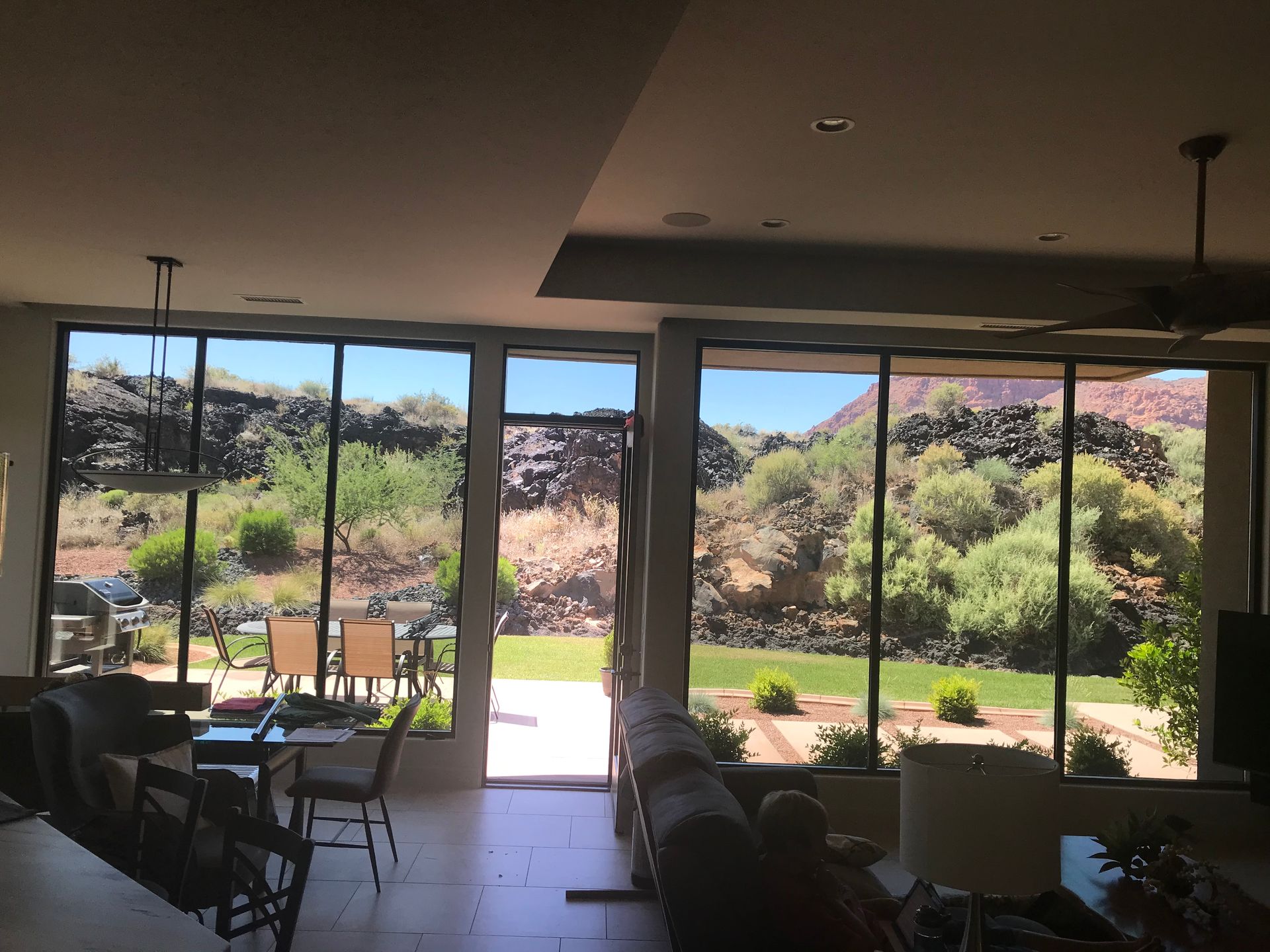 A living room with a lot of windows and a view of the mountains