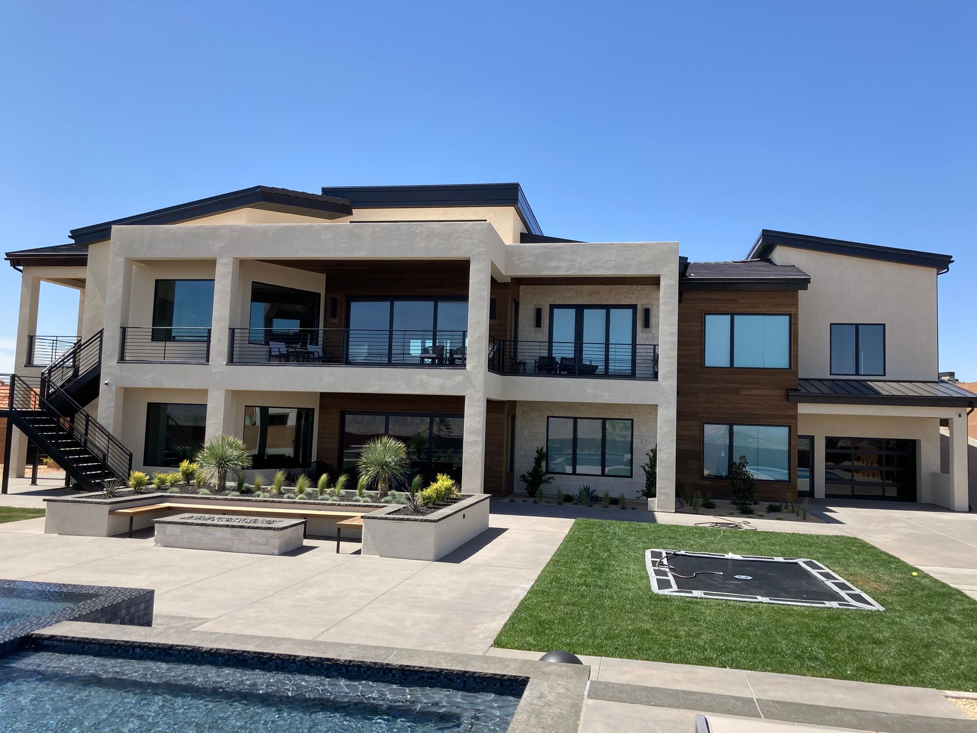 A large house with a swimming pool in front of it.