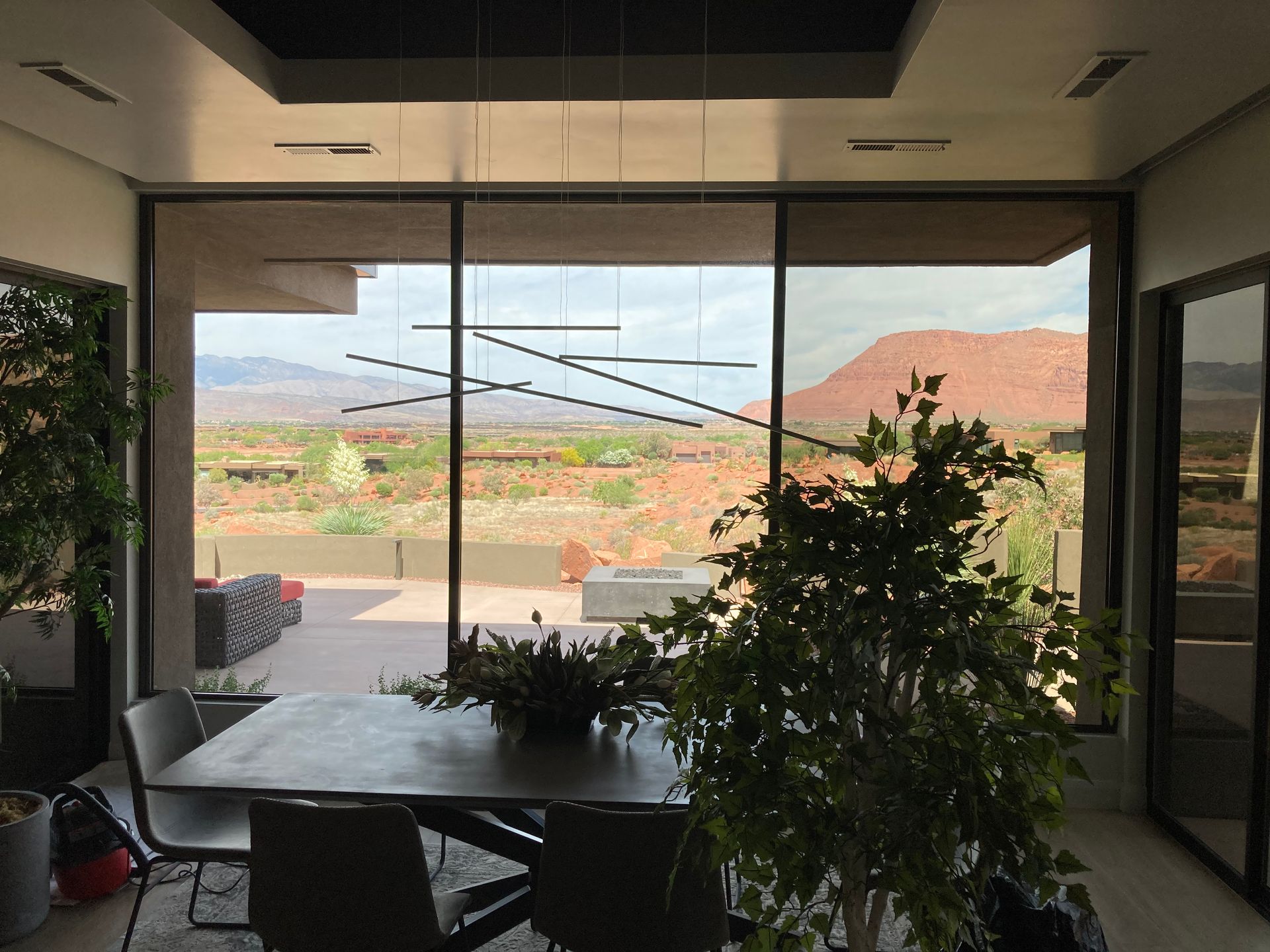 A dining room with a table and chairs and a view of the desert