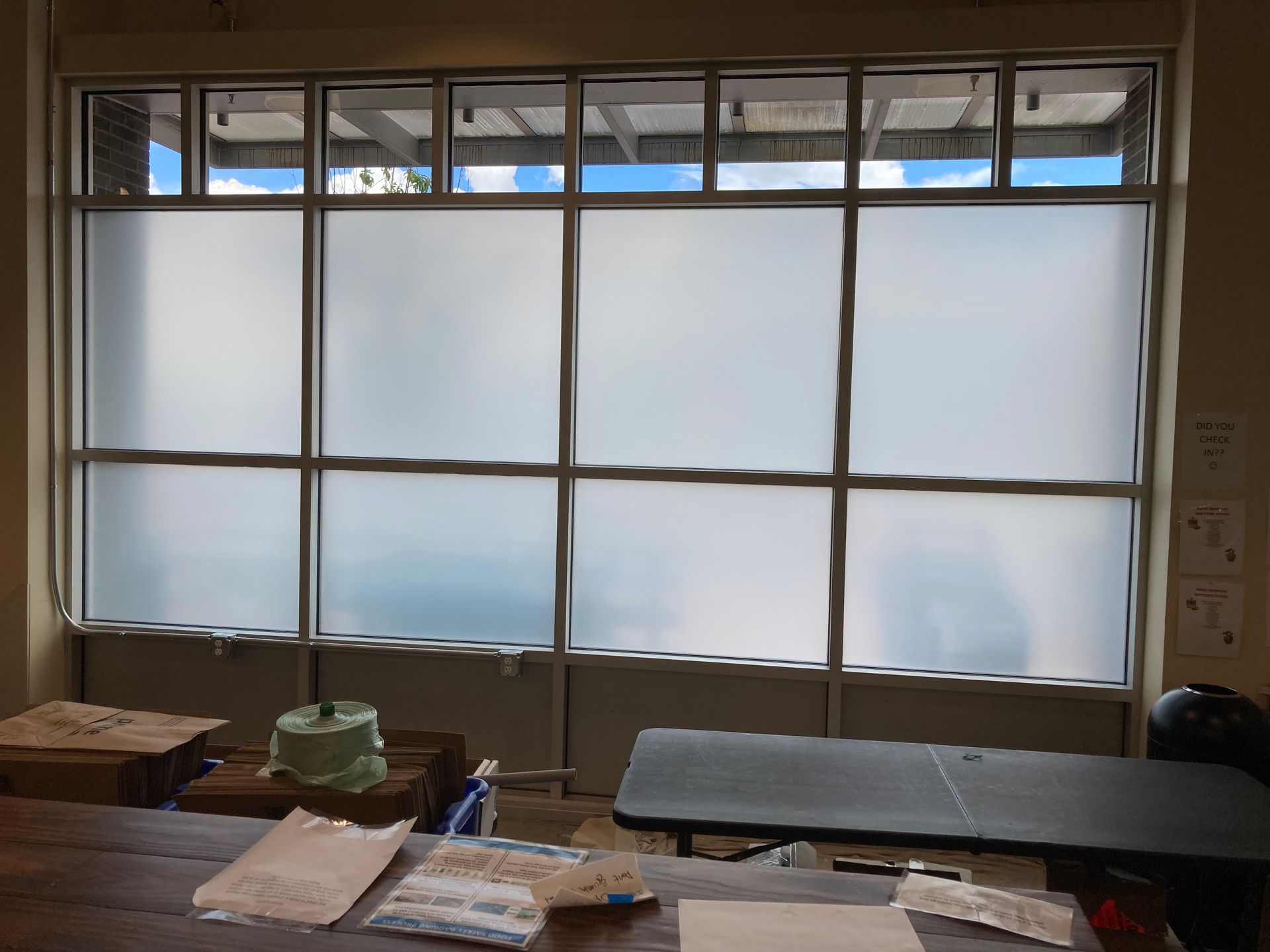 A room with a lot of windows and a table