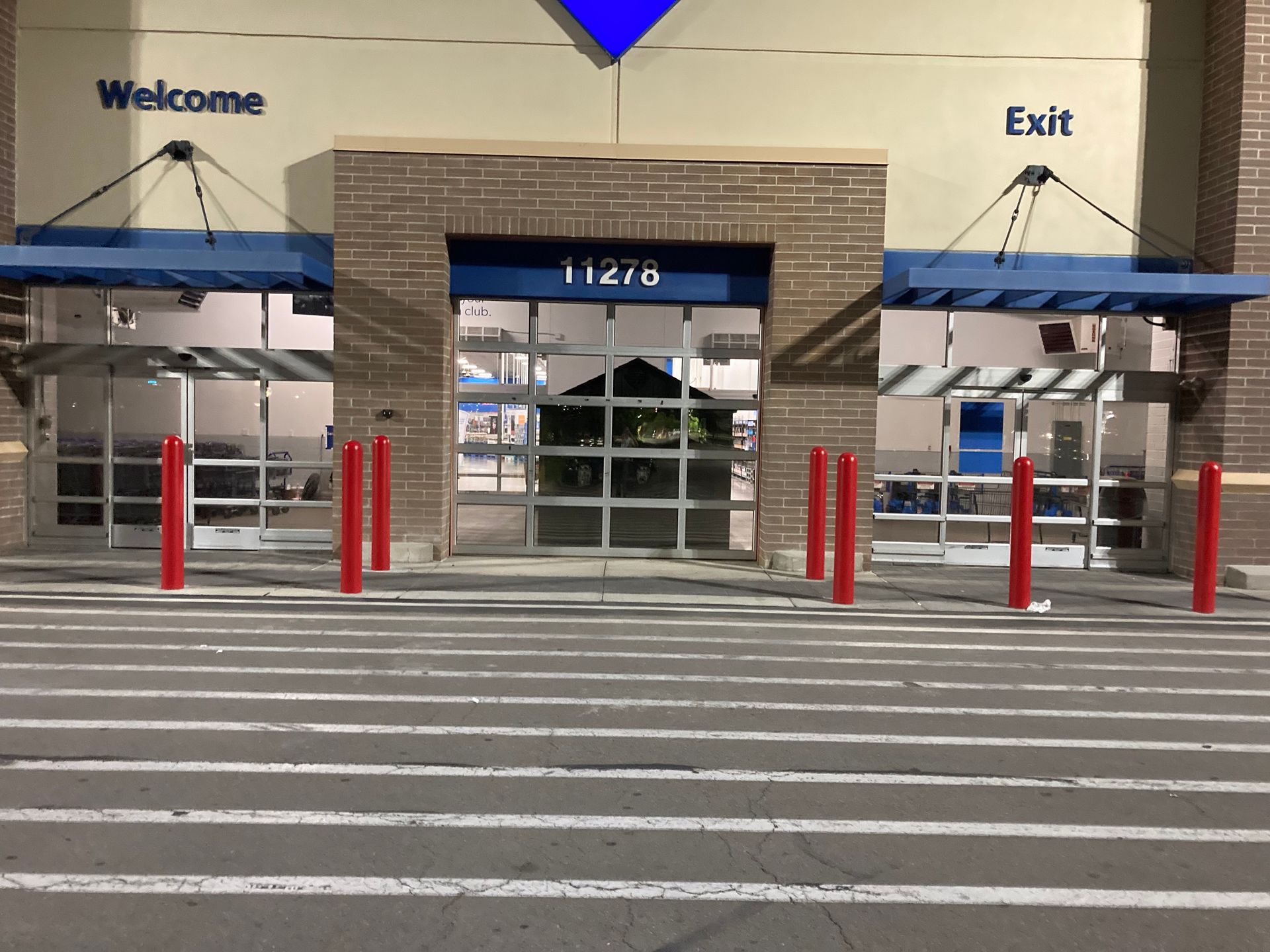 The front of a store with a welcome sign and exit sign