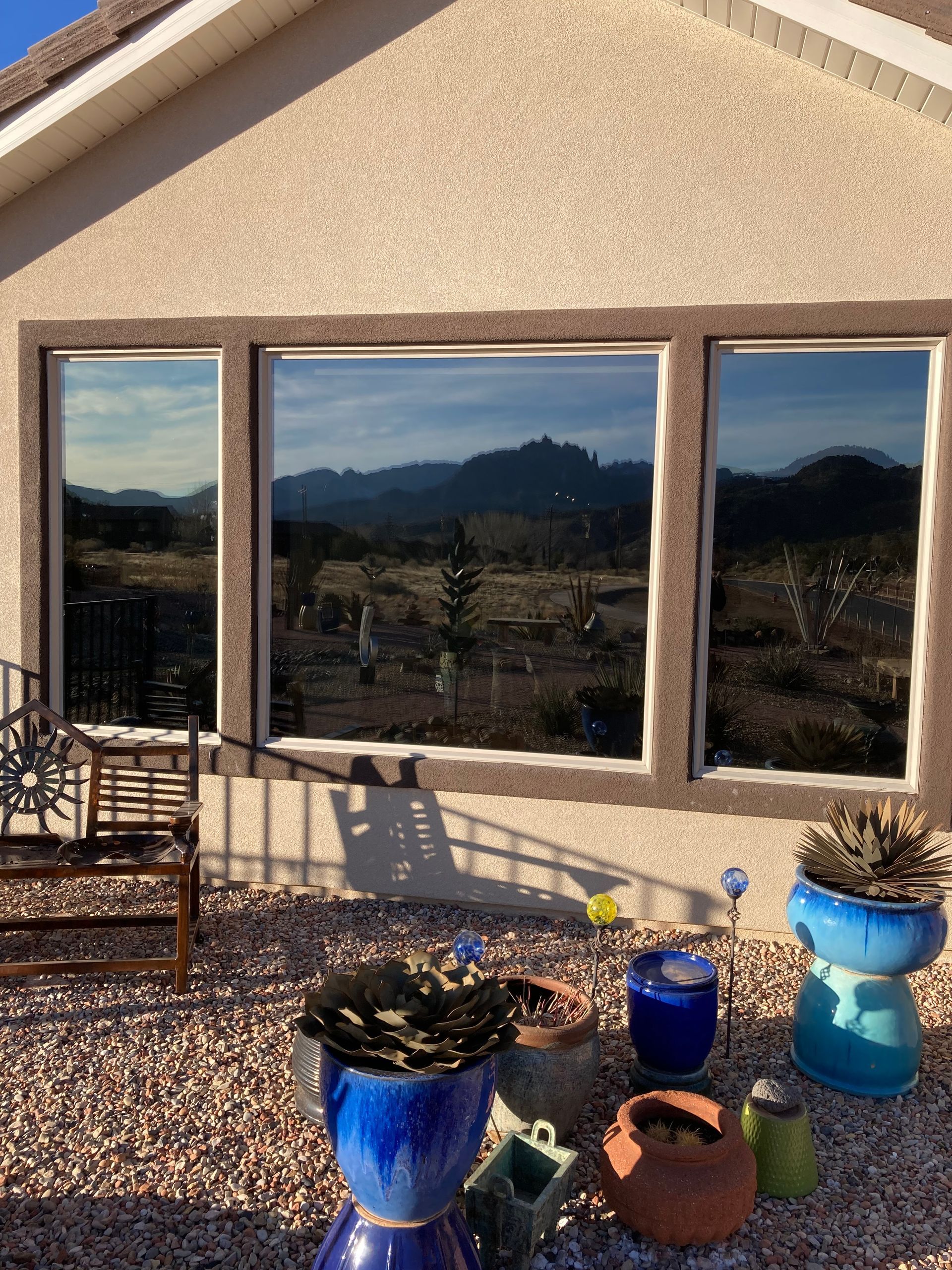 A house with a lot of potted plants in front of it