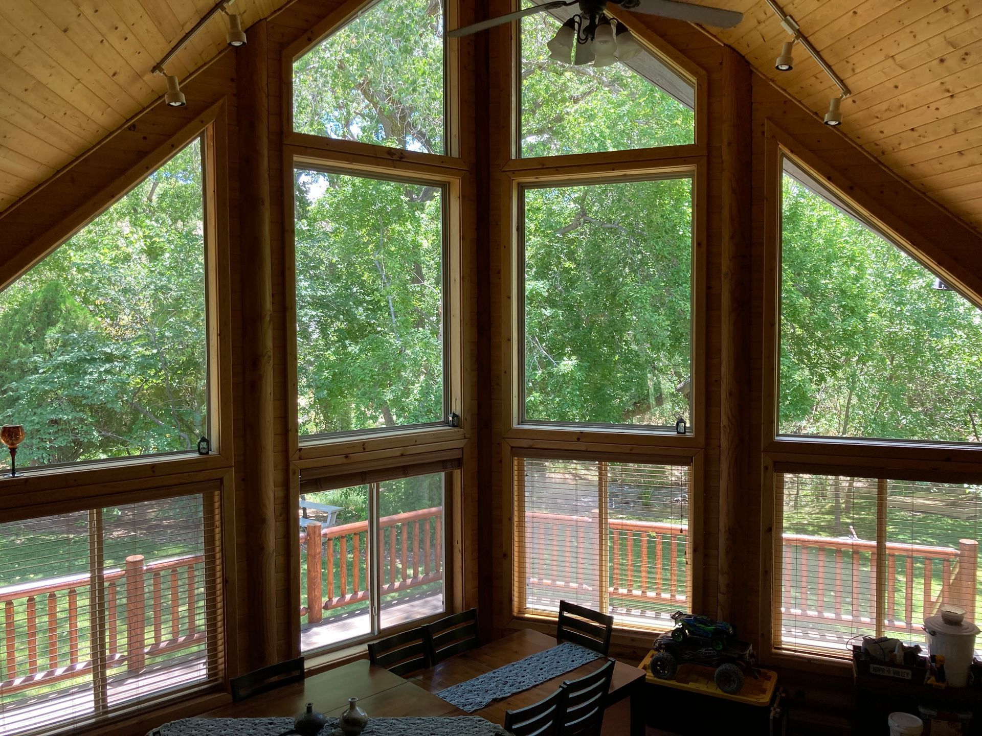 A room with a lot of windows and a ceiling fan