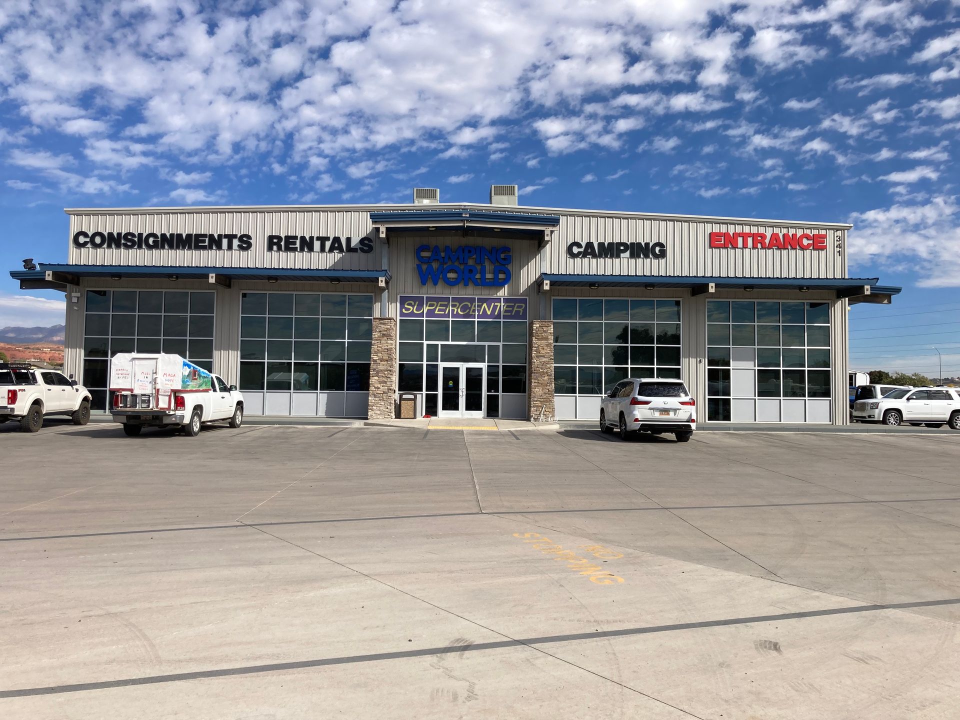 A large building with a lot of windows and cars parked in front of it.