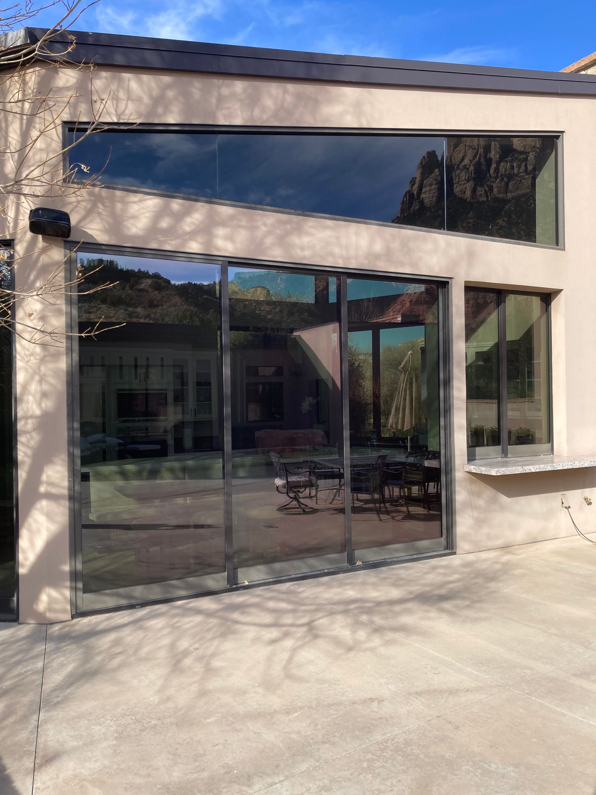 A house with a lot of windows and sliding glass doors