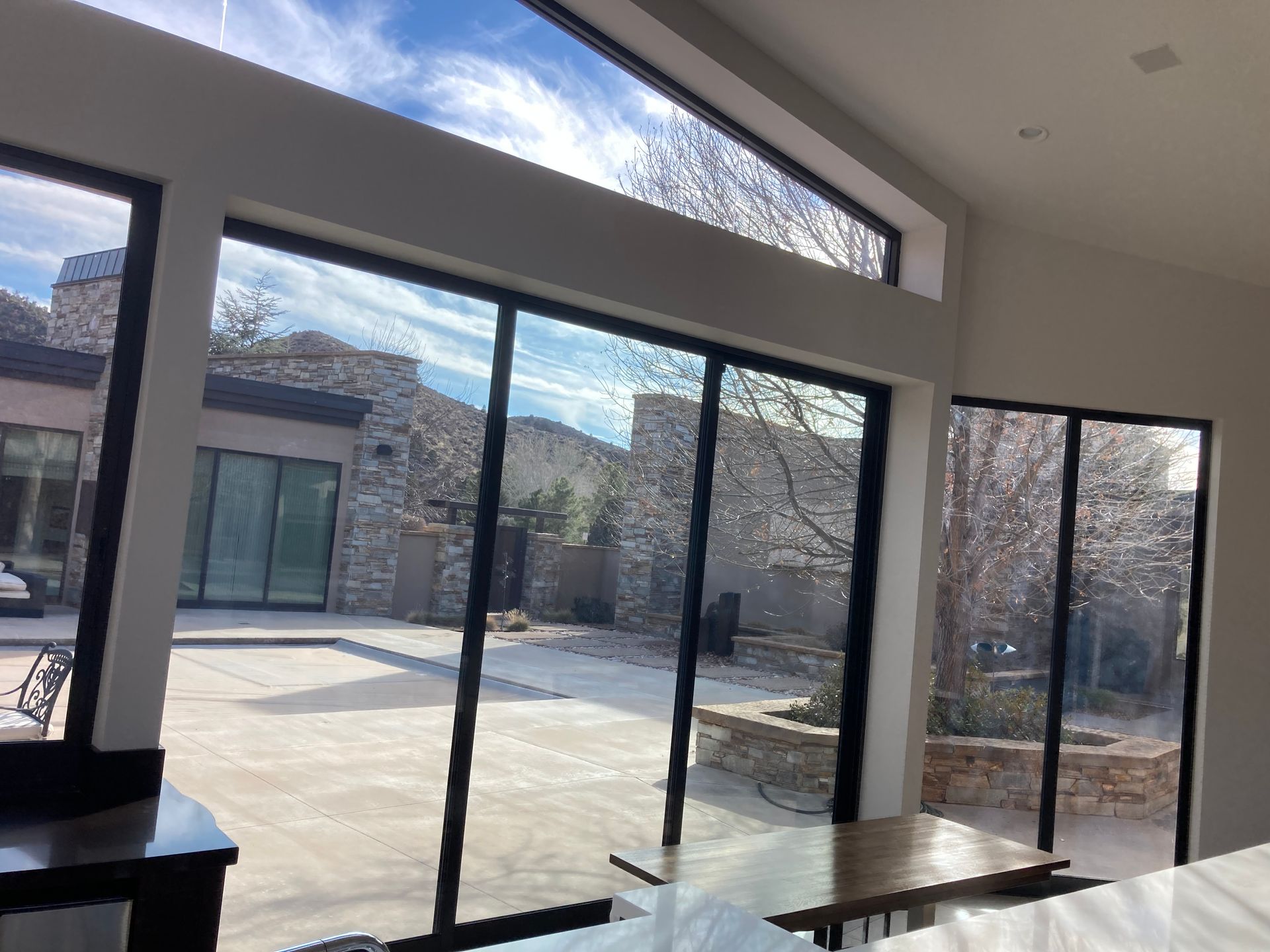 A room with a lot of windows and a table