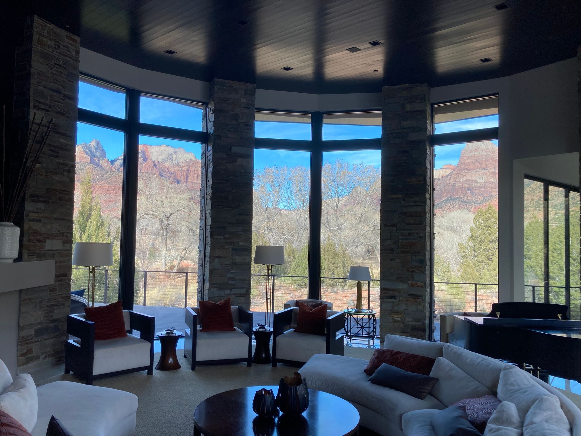 A living room with a lot of windows and a couch