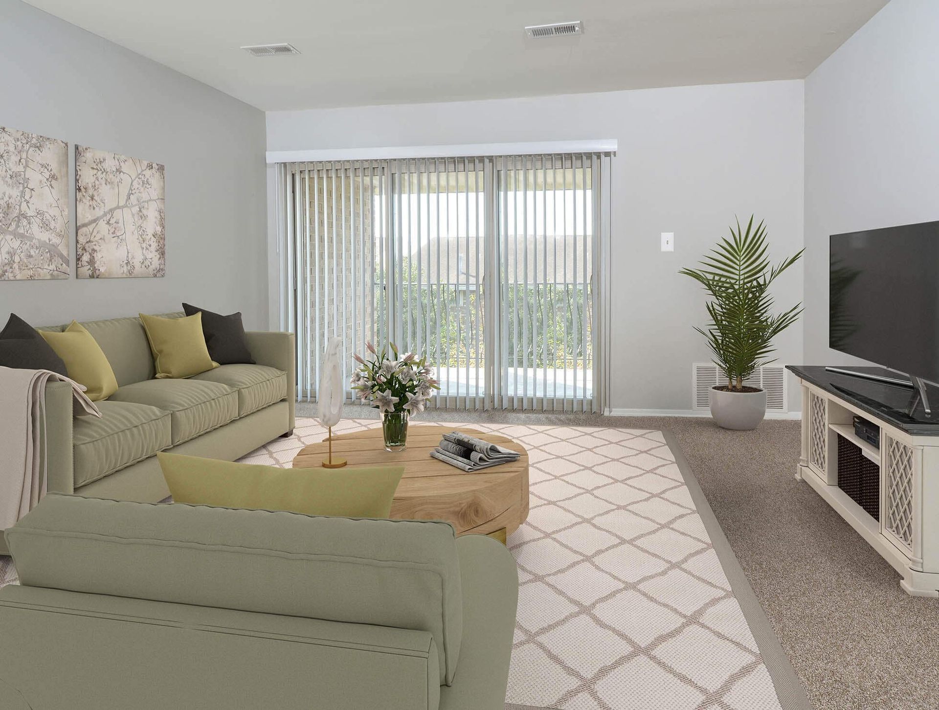 Living room with sage-green sofa, coffee table, TV stand, plant, and sliding glass doors with vertical blinds.