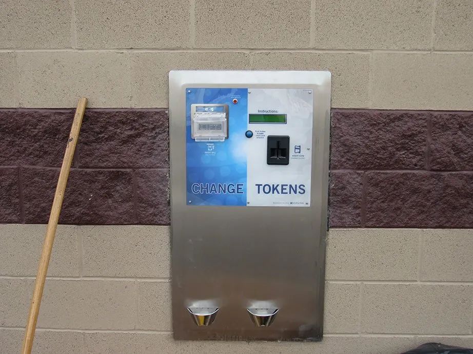 A machine on a wall that says storage tokens