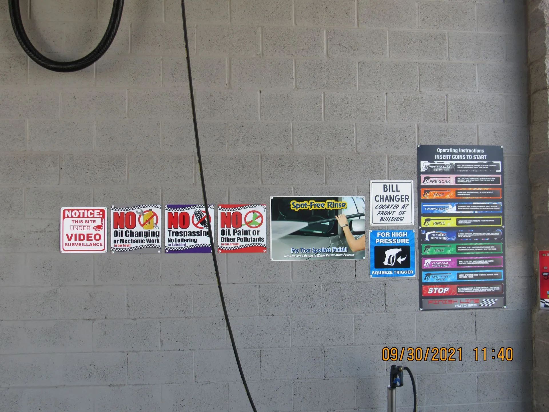 A brick wall with a bunch of signs on it