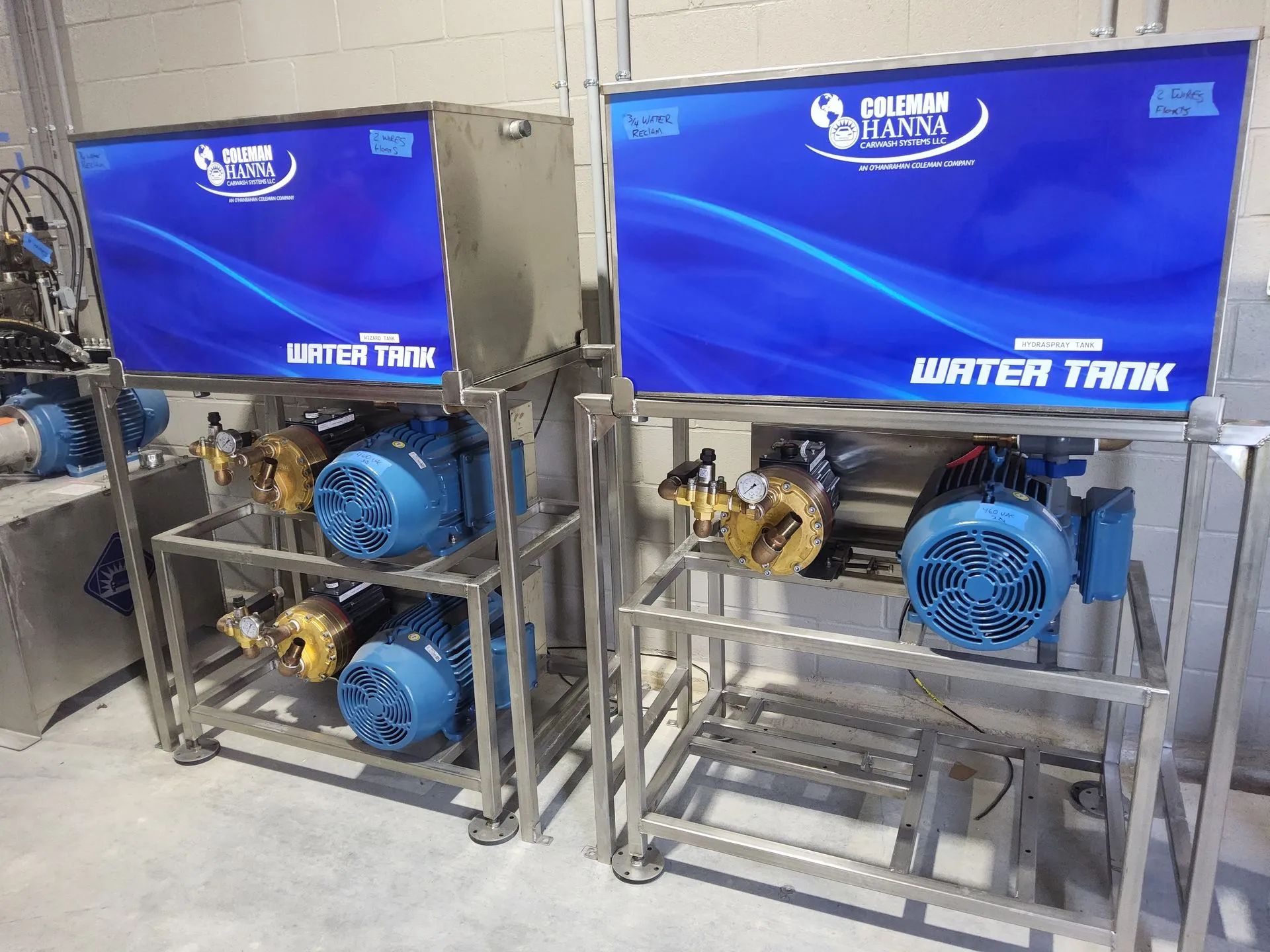 Two water tanks are sitting next to each other in a room.