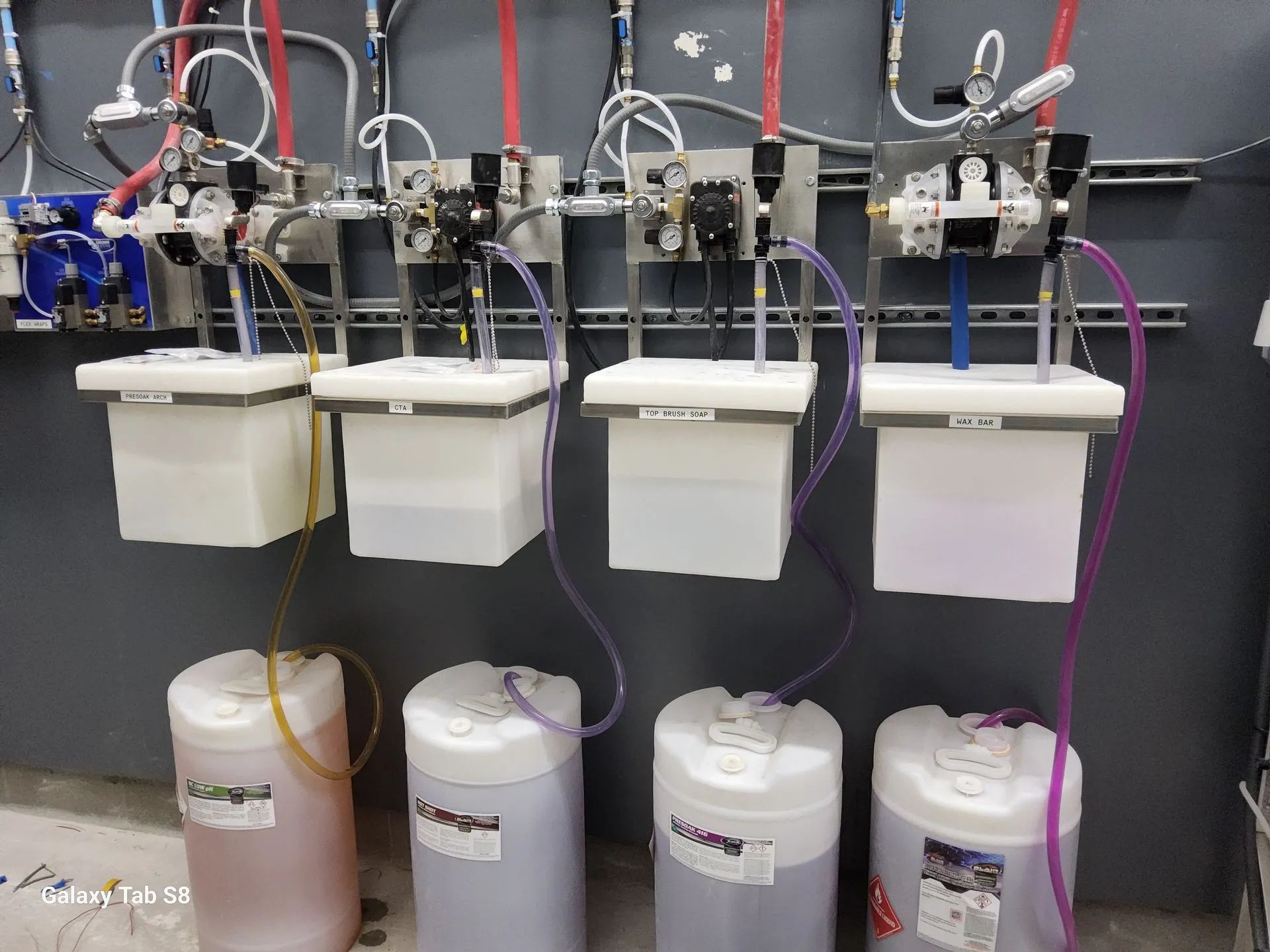 A row of containers filled with different colored liquids