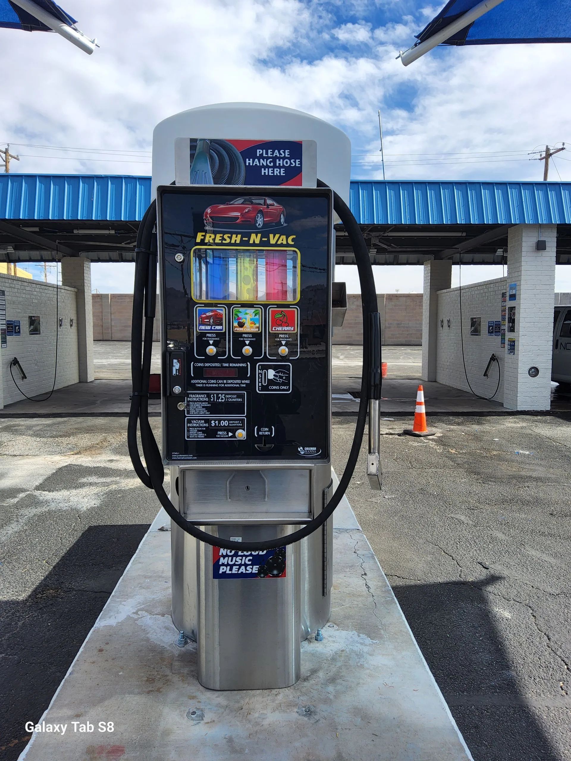 A car wash machine with a hose attached to it.