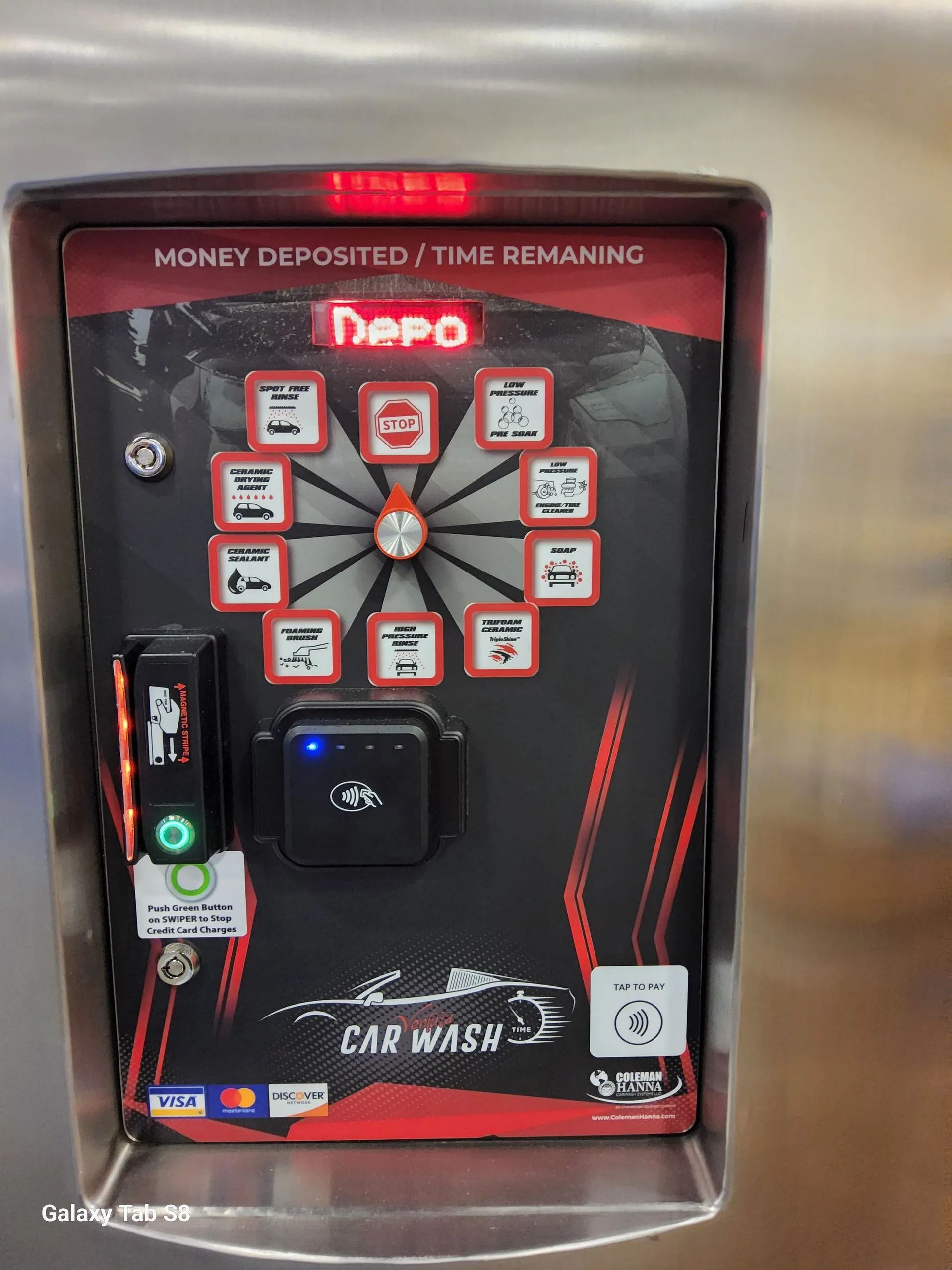 A car wash machine with a dart board on it.