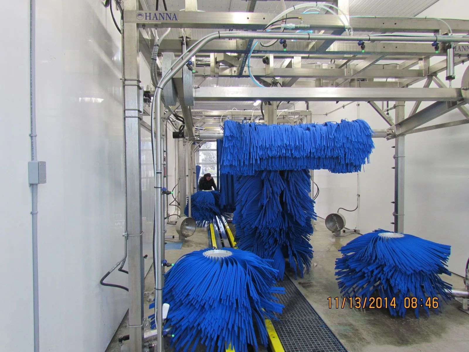 A car wash with blue brushes on a conveyor belt