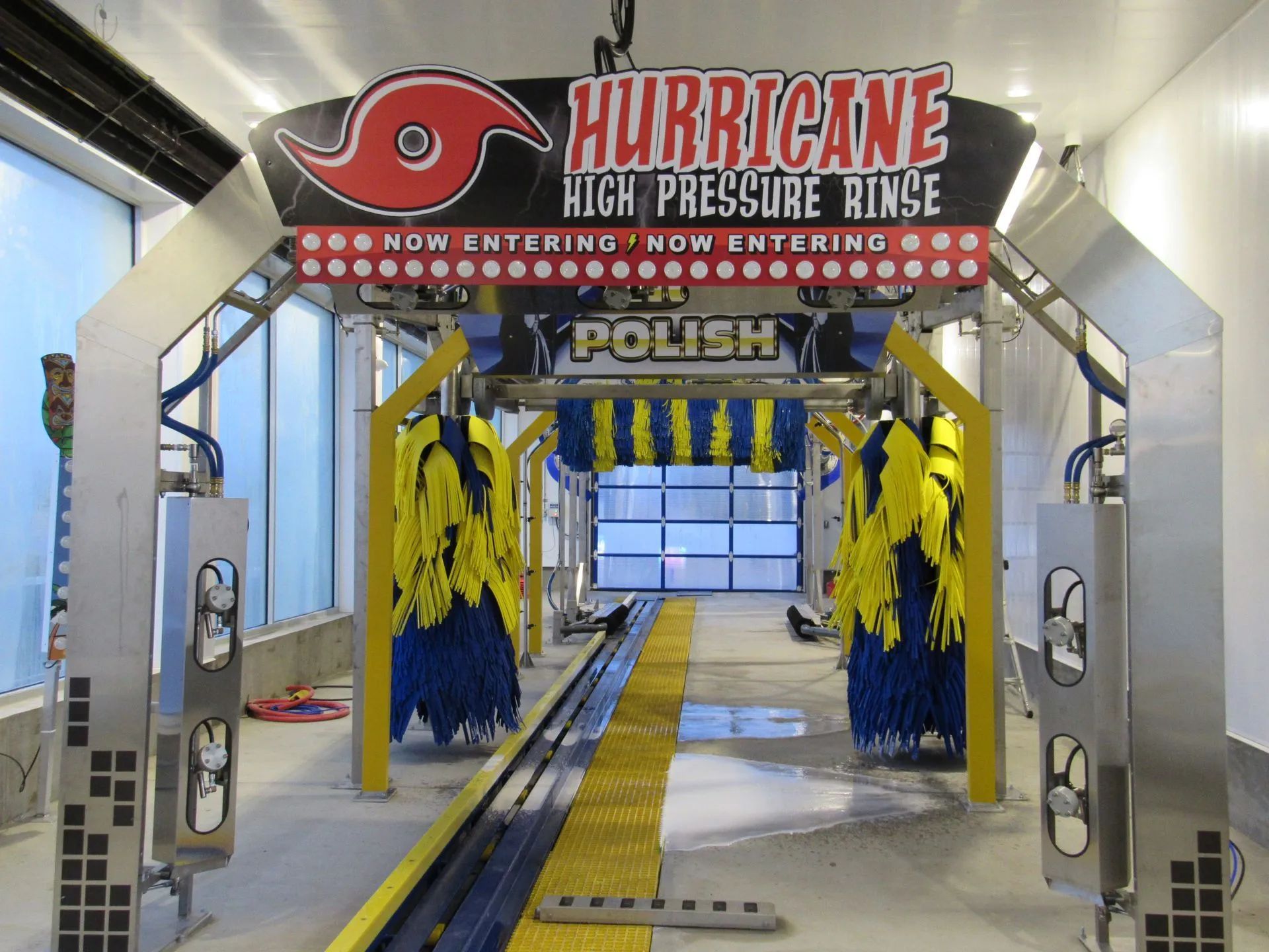 A car wash with a sign that says hurricane high pressure rinse