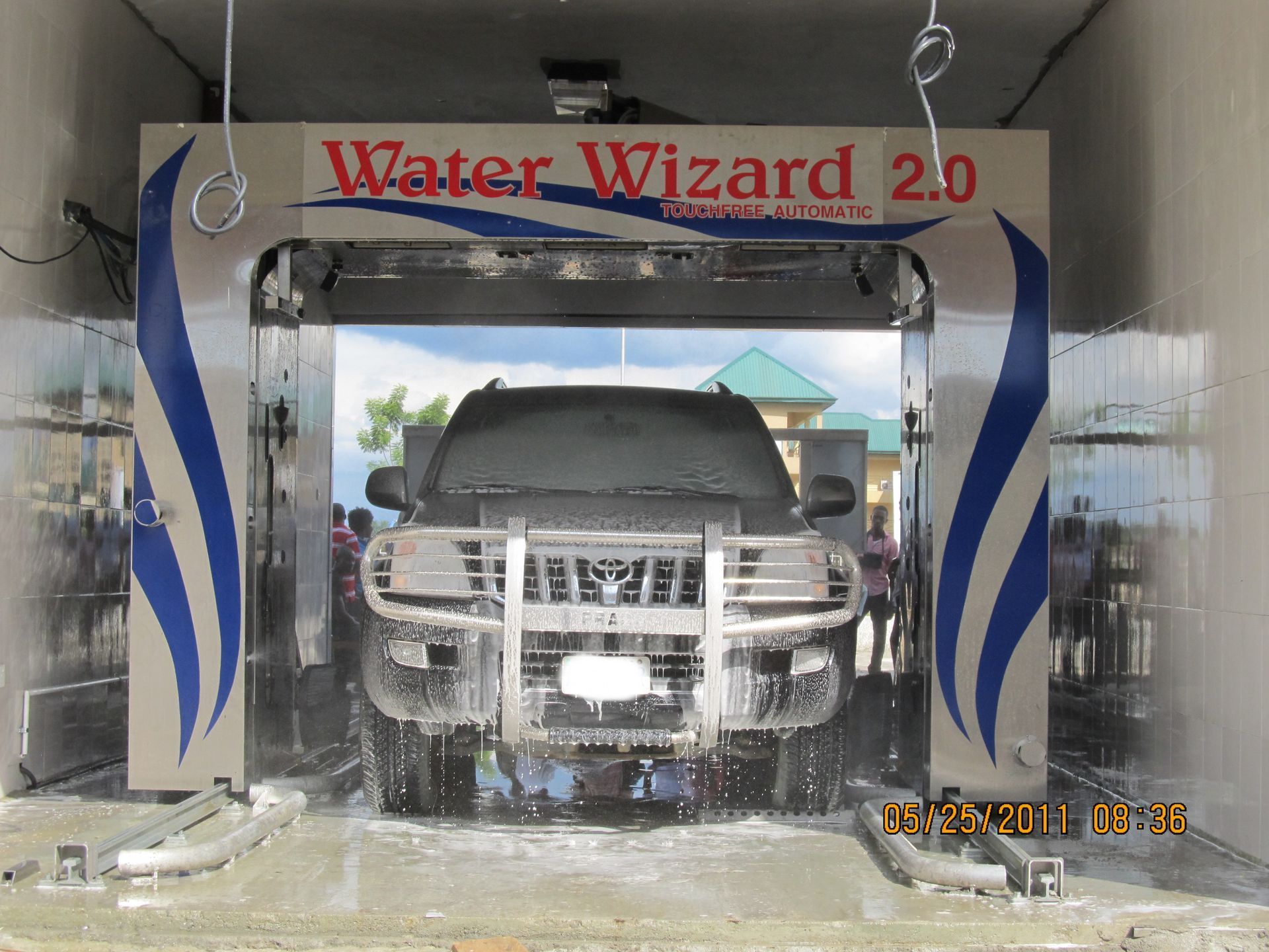 A black SUV is being washed inside a 