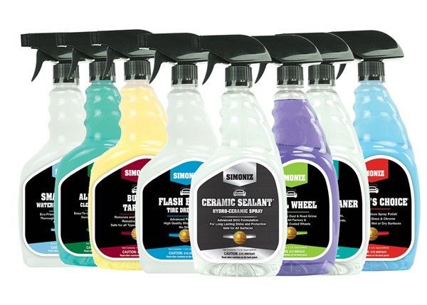 Seven spray bottles of car cleaning products with various colors and labels.