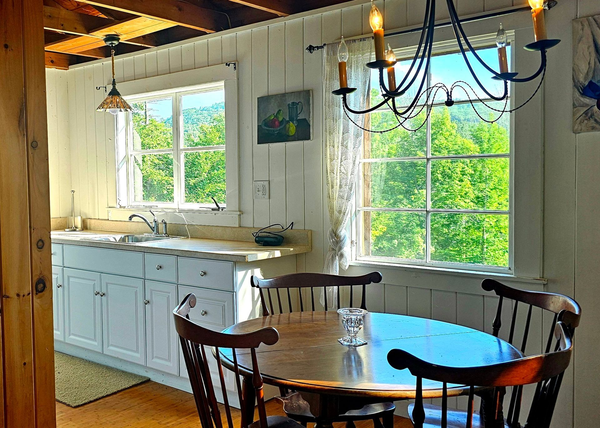 A kitchen with a table and chairs and a chandelier