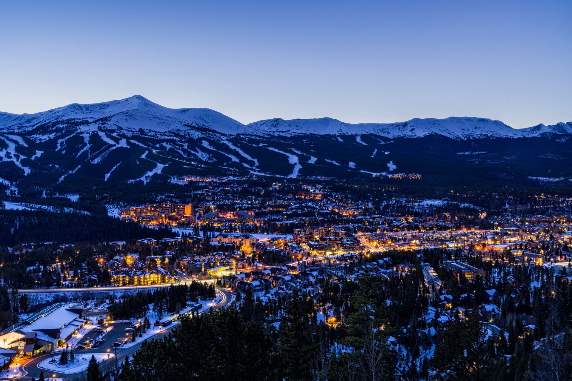 Breckenridge Colorado Winter Dusk Ski Runs - Landscape scenic at dusk during blur hour showing ski resort runs and town of Breckenridge lit up in winter. Breckenridge, Colorado USA.