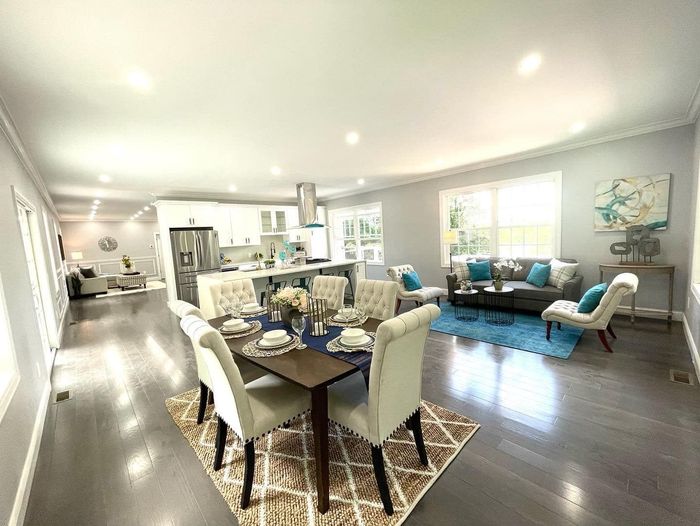 A living room with a dining table and chairs and a couch.