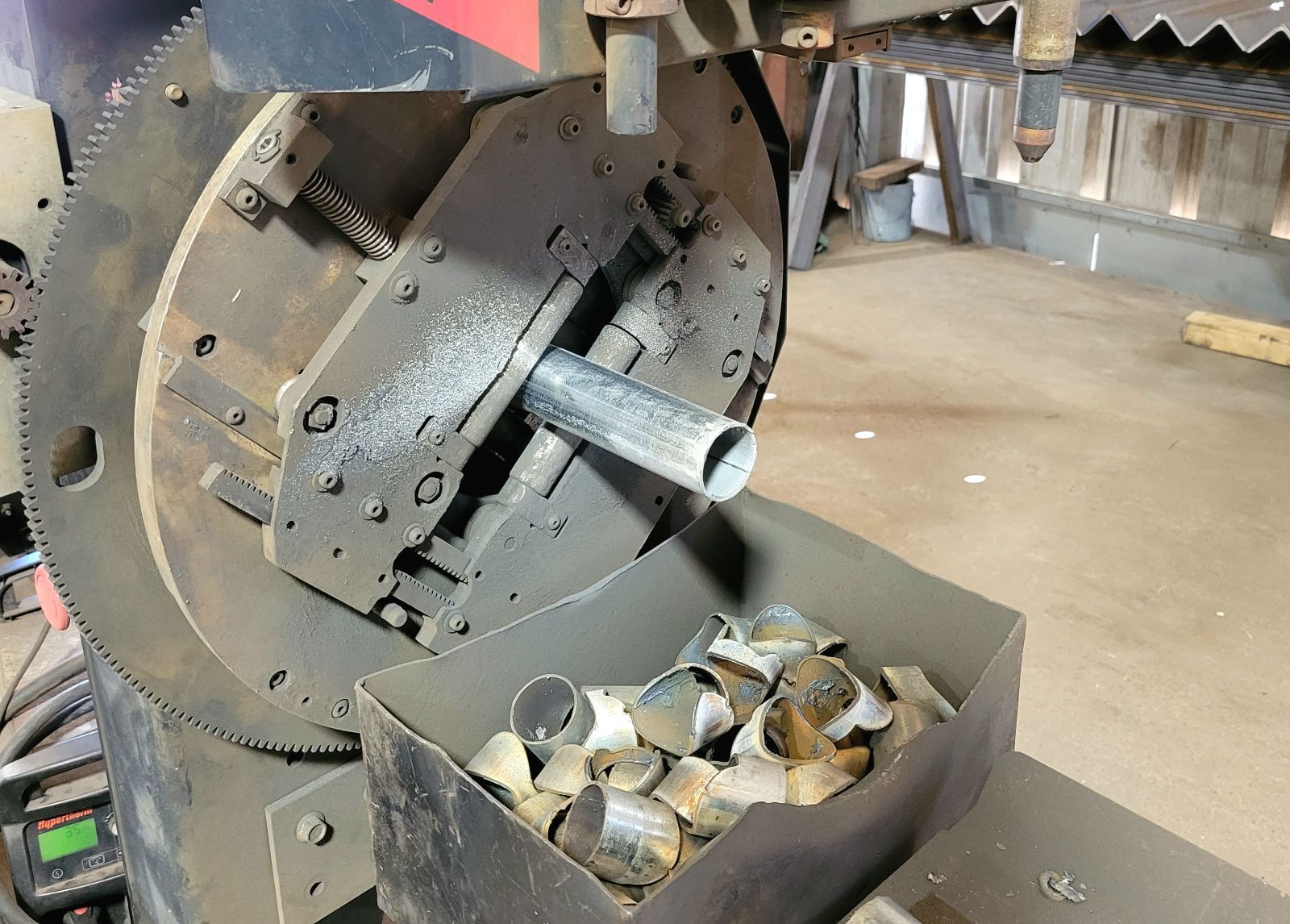 A machine is being used to cut a metal pipe